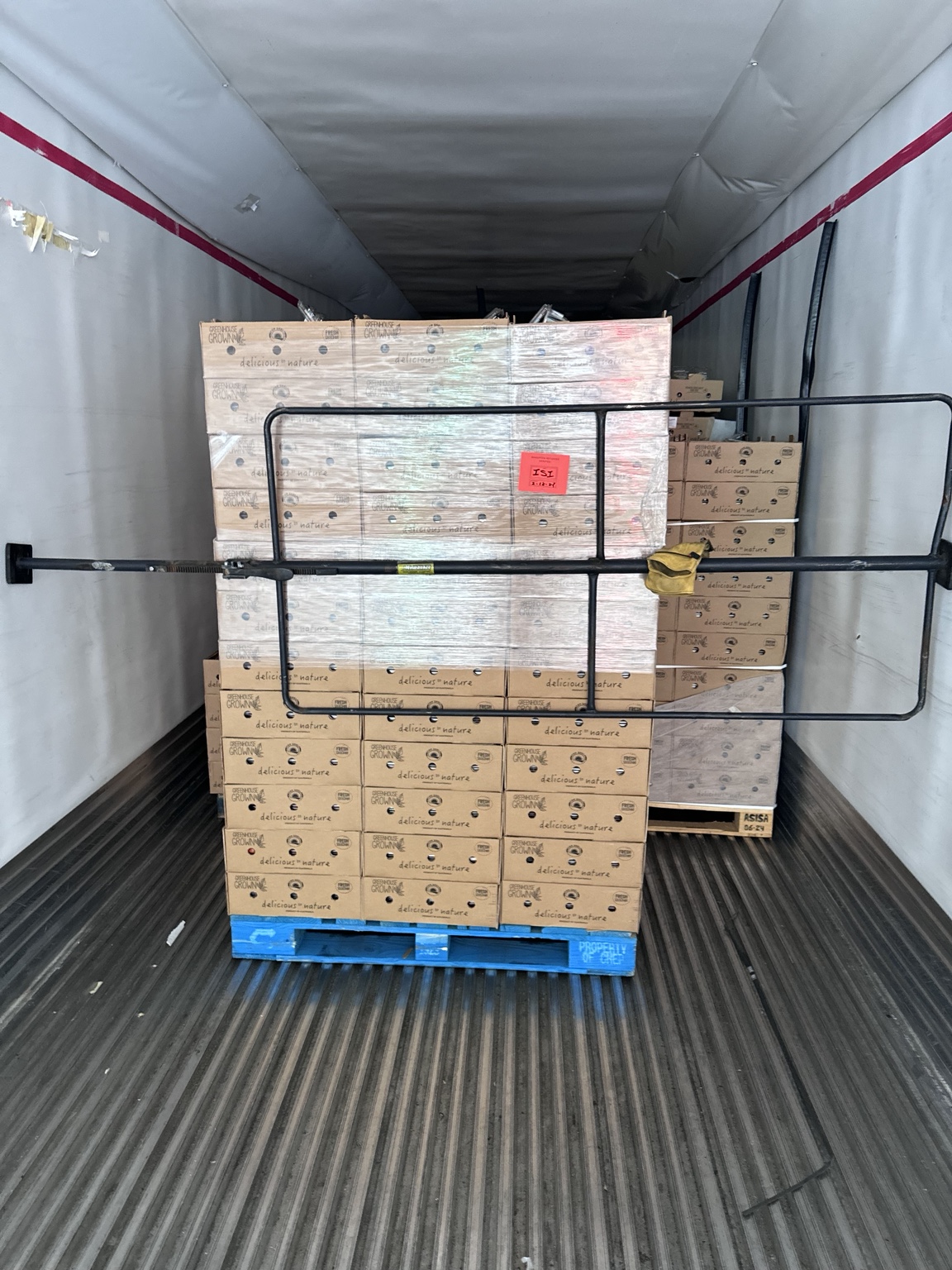 Palletized produce secured inside refrigerated trailer