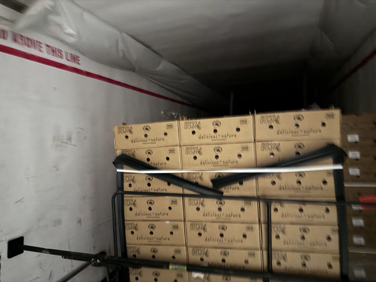 Produce load secured with cargo bars inside trailer